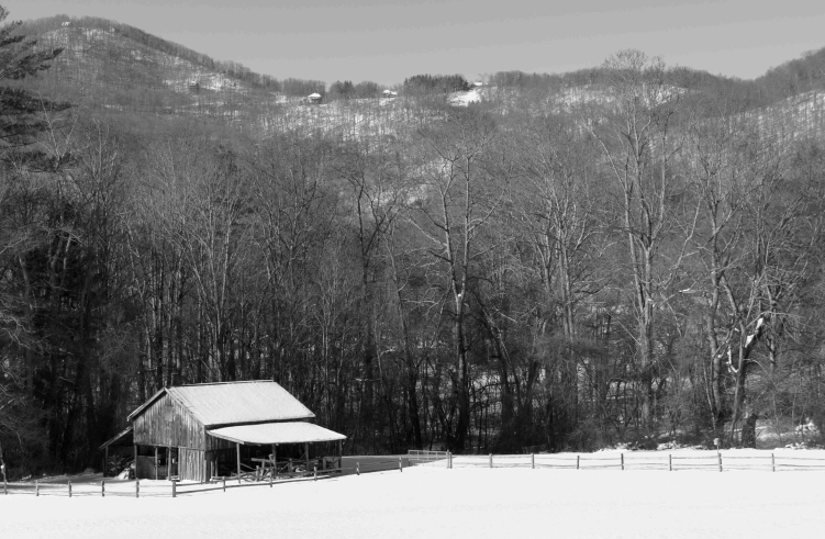 Image of a barn in a valley in winter